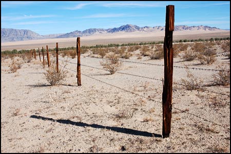 A fence is still stands in the desert